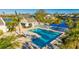 Resort style community pool area with covered seating, palm trees, and lake view at 11371 Perico Isle Cir, Bradenton, FL 34209