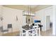 Eat-in kitchen features a modern light fixture and bright sunlight at 11371 Perico Isle Cir, Bradenton, FL 34209