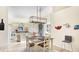 View of the dining area with updated lighting and a view into the kitchen, featuring ample seating at 11371 Perico Isle Cir, Bradenton, FL 34209