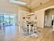 Coastal dining area features vaulted ceilings and sliding doors to the screened lanai at 11371 Perico Isle Cir, Bradenton, FL 34209
