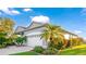 Beautiful single-story home featuring an attached garage, a well-kept lawn and mature tropical landscaping at 11371 Perico Isle Cir, Bradenton, FL 34209