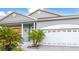 Charming single-story home with attached garage, manicured landscaping, and covered entryway at 11371 Perico Isle Cir, Bradenton, FL 34209