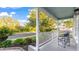 Inviting front porch with views of the street, a comfy chair, and lush tropical landscaping at 11371 Perico Isle Cir, Bradenton, FL 34209