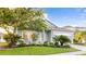 Charming single-story home featuring mature landscaping, a welcoming front porch, and a well-maintained lawn at 11371 Perico Isle Cir, Bradenton, FL 34209