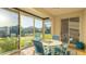 Screened-in lanai with seating, tiled flooring and views of the backyard and water at 11371 Perico Isle Cir, Bradenton, FL 34209
