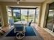 Enclosed lanai featuring tile flooring, patio table and chairs, and views of a serene pond at 11371 Perico Isle Cir, Bradenton, FL 34209