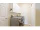 Efficient laundry room with modern washer and dryer, storage and folding space at 11371 Perico Isle Cir, Bradenton, FL 34209