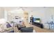Bright living room with vaulted ceilings, wood-look flooring, a ceiling fan and modern furnishings at 11371 Perico Isle Cir, Bradenton, FL 34209