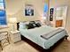 Comfortable main bedroom with shuttered windows and ensuite bathroom at 11371 Perico Isle Cir, Bradenton, FL 34209