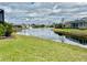 Beautiful backyard pond view featuring a fountain and a lush green lawn at 11371 Perico Isle Cir, Bradenton, FL 34209
