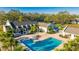 Community pool with palm trees, tennis courts, and building in the background at 11371 Perico Isle Cir, Bradenton, FL 34209
