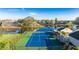 Aerial shot of a community tennis court next to a pond and other homes at 11371 Perico Isle Cir, Bradenton, FL 34209