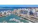 Aerial view showcases city skyline, harbor, and luxury residential building at 1155 N Gulfstream Ave # 1205, Sarasota, FL 34236