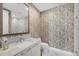 Bathroom featuring stylish patterned wallpaper, a vanity with storage, and a tiled shower at 1155 N Gulfstream Ave # 1205, Sarasota, FL 34236