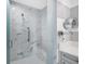 Sleek walk-in shower with marble-like tile, featuring a built-in seat and grab bar for accessibility at 1155 N Gulfstream Ave # 1205, Sarasota, FL 34236