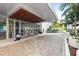 Grand building entrance with modern architecture, manicured landscaping and circular driveway at 1155 N Gulfstream Ave # 1205, Sarasota, FL 34236