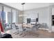 Bright dining room boasts modern chandelier, sleek furniture, and access to the outdoor balcony at 1155 N Gulfstream Ave # 1205, Sarasota, FL 34236