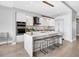 Bright kitchen with white cabinets, waterfall island, and seating provides a modern, functional space for cooking and entertaining at 1155 N Gulfstream Ave # 1205, Sarasota, FL 34236