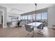 Open-concept living and dining area features floor-to-ceiling windows with stunning water views at 1155 N Gulfstream Ave # 1205, Sarasota, FL 34236
