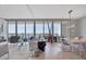Elegant condo living space with floor-to-ceiling windows showcasing incredible waterfront and city vistas at 1155 N Gulfstream Ave # 1205, Sarasota, FL 34236