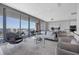 Open living space with expansive windows, contemporary furniture, and stunning views of the city at 1155 N Gulfstream Ave # 1205, Sarasota, FL 34236