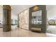 Contemporary lobby with decorative wall features, a pillar, neutral colors, and floor to ceiling windows at 1155 N Gulfstream Ave # 1205, Sarasota, FL 34236
