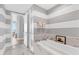 Elegant bathroom with a soaking tub, stylish marble accents, and a modern design at 1155 N Gulfstream Ave # 1205, Sarasota, FL 34236