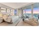 Serene main bedroom offers stunning water views, a cozy chaise lounge, and ample natural light at 1155 N Gulfstream Ave # 1205, Sarasota, FL 34236