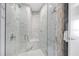 Luxurious shower space is complete with marble tile, a glass enclosure, and a bench at 1155 N Gulfstream Ave # 1205, Sarasota, FL 34236