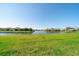 Expansive green backyard overlooking a serene community lake at 12140 Whisper Lake Dr, Bradenton, FL 34211