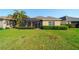 Backyard view of a home featuring a screened patio and lush landscaping at 12140 Whisper Lake Dr, Bradenton, FL 34211
