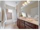Bathroom boasts dual sink vanity, tile floors, and combined shower and tub at 12140 Whisper Lake Dr, Bradenton, FL 34211