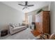 Cozy sitting room with sofa, ceiling fan, and shuttered window at 12140 Whisper Lake Dr, Bradenton, FL 34211