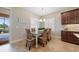 Dining area with table, wicker chairs, and plantation shutters at 12140 Whisper Lake Dr, Bradenton, FL 34211