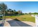 Large, fenced-in dog park includes grassy play area, trees, and walkway at 12140 Whisper Lake Dr, Bradenton, FL 34211