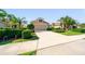 Single-story home featuring a manicured lawn, landscaping, and a two-car garage at 12140 Whisper Lake Dr, Bradenton, FL 34211