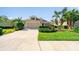 Charming home featuring a well-manicured lawn and mature landscaping at 12140 Whisper Lake Dr, Bradenton, FL 34211