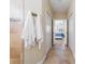 Hallway features neutral paint, tile floor, and access to bathroom and bedroom at 12140 Whisper Lake Dr, Bradenton, FL 34211