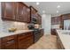 Well-equipped kitchen with dark wood cabinetry, tiled backsplash, and stainless steel appliances at 12140 Whisper Lake Dr, Bradenton, FL 34211
