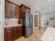 Kitchen featuring stainless steel refrigerator, wood cabinets, and tile backsplash at 12140 Whisper Lake Dr, Bradenton, FL 34211