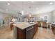 Open concept kitchen with island, dining area, and living room at 12140 Whisper Lake Dr, Bradenton, FL 34211