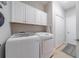 Modern laundry room featuring a front load washer and dryer at 12140 Whisper Lake Dr, Bradenton, FL 34211
