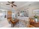 Cozy living room featuring a large built-in bookcase and warm neutral tones at 12140 Whisper Lake Dr, Bradenton, FL 34211