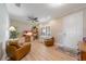 Bright living room with hardwood floors, a ceiling fan, and a comfortable seating area at 12140 Whisper Lake Dr, Bradenton, FL 34211