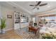 Spacious living room with a built-in shelving unit, tile flooring, and comfortable seating at 12140 Whisper Lake Dr, Bradenton, FL 34211