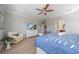 Bright main bedroom with ceiling fan, dresser, and door leading to bathroom at 12140 Whisper Lake Dr, Bradenton, FL 34211