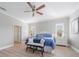 Bright bedroom with ceiling fan, bench, and view of the windows at 12140 Whisper Lake Dr, Bradenton, FL 34211