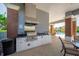 Outdoor kitchen features stainless steel grill, granite countertop, cabinetry, and trash receptacle near the community pool at 12140 Whisper Lake Dr, Bradenton, FL 34211