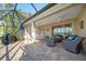 Relaxing covered patio with comfortable seating, ceiling fans, and views of the lake and tropical landscaping at 12140 Whisper Lake Dr, Bradenton, FL 34211
