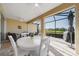 Spacious screened-in patio with a dining table and comfortable seating area, perfect for entertaining at 12140 Whisper Lake Dr, Bradenton, FL 34211
